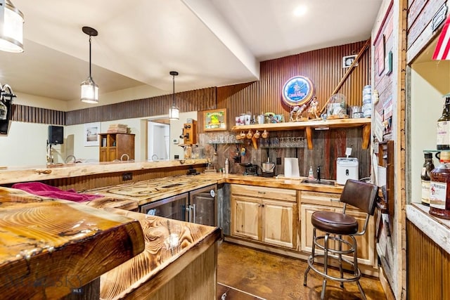 bar featuring concrete flooring, wood walls, and hanging light fixtures