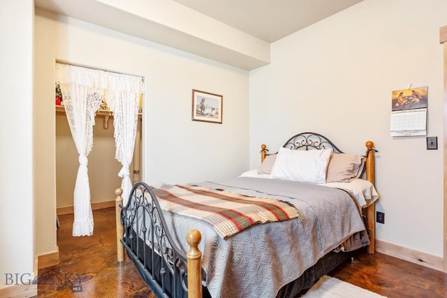 bedroom with baseboards and concrete floors