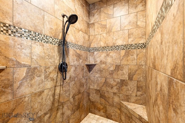 interior details with a tile shower