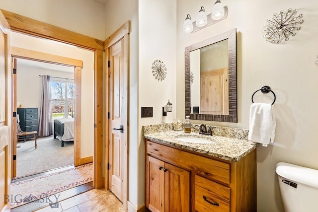 bathroom featuring vanity, tile patterned floors, and toilet