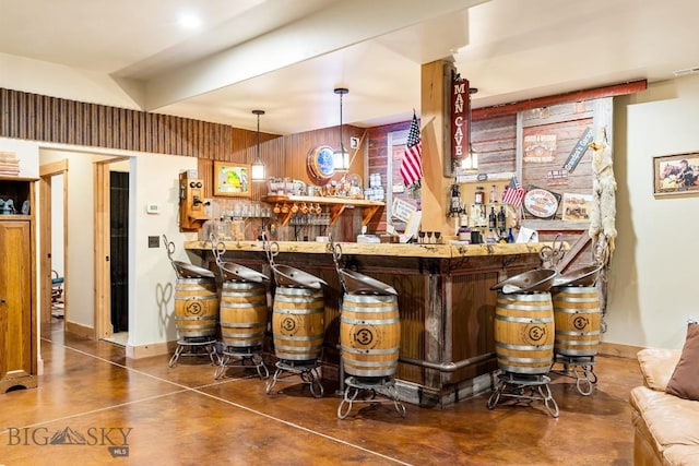 bar with finished concrete floors, visible vents, decorative light fixtures, and a bar