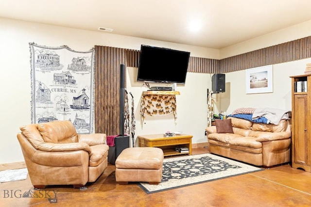 living area with concrete flooring and visible vents