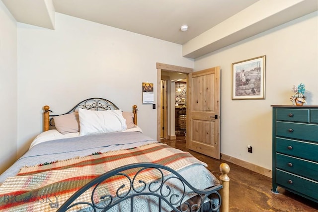 bedroom featuring baseboards and concrete floors