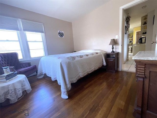 bedroom with dark wood-style floors
