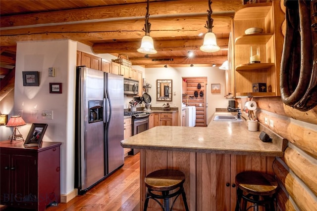 kitchen featuring a peninsula, a sink, open shelves, stainless steel appliances, and light wood-type flooring