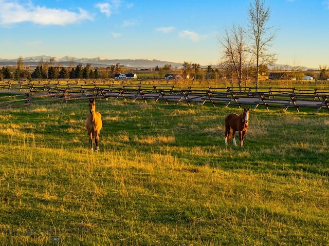 624 Rocking Horse Dr, Bozeman, MT 59718 - surrounding community with fence, a mountain view, and a rural view