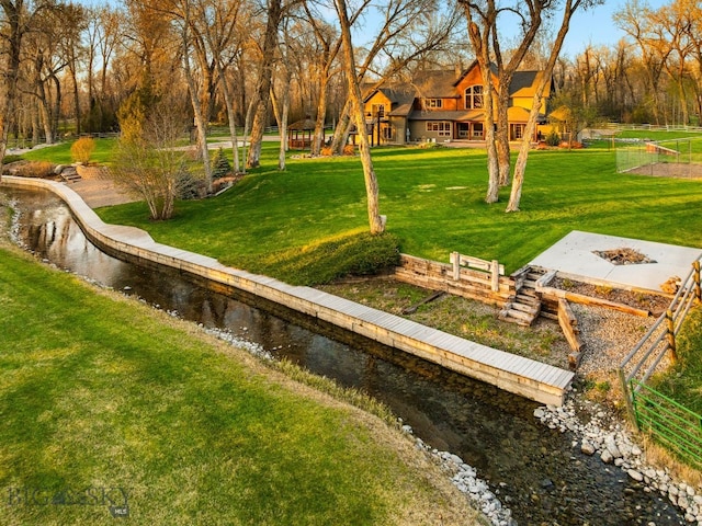 624 Rocking Horse Dr, Bozeman, MT 59718 - surrounding community featuring a water view, an outdoor fire pit, fence, and a yard
