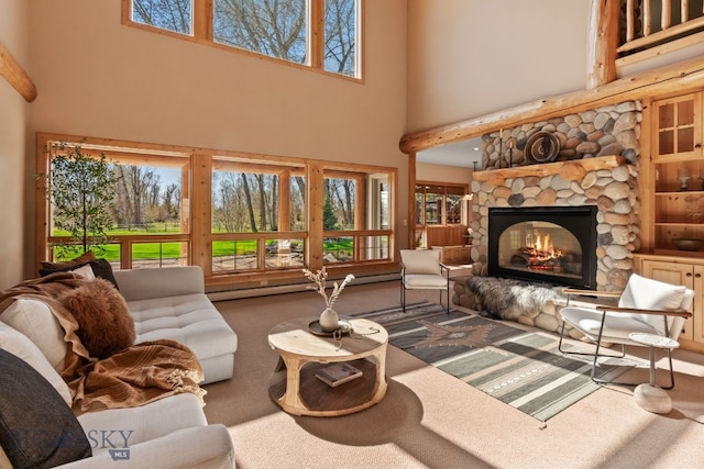 624 Rocking Horse Dr, Bozeman, MT 59718 - carpeted living area featuring a stone fireplace, a towering ceiling, and a wealth of natural light