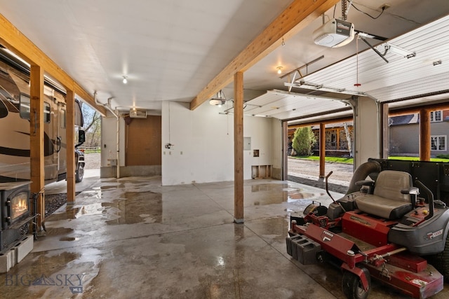 624 Rocking Horse Dr, Bozeman, MT 59718 - garage featuring a wood stove and a garage door opener