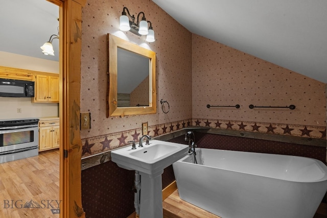 624 Rocking Horse Dr, Bozeman, MT 59718 - full bath featuring wallpapered walls, wood finished floors, and lofted ceiling