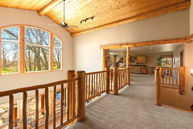 624 Rocking Horse Dr, Bozeman, MT 59718 - hall featuring carpet floors, an upstairs landing, wooden ceiling, and vaulted ceiling with beams