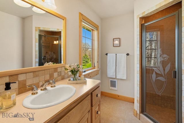 624 Rocking Horse Dr, Bozeman, MT 59718 - bathroom featuring vanity, tile patterned floors, baseboards, visible vents, and a stall shower