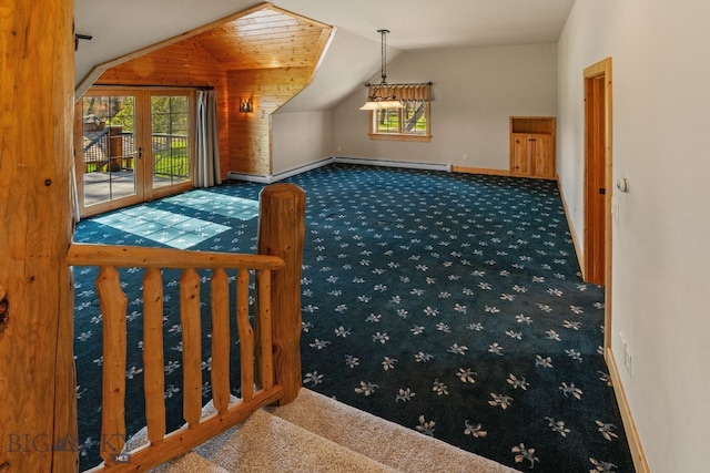 624 Rocking Horse Dr, Bozeman, MT 59718 - additional living space with baseboards, vaulted ceiling, baseboard heating, and carpet