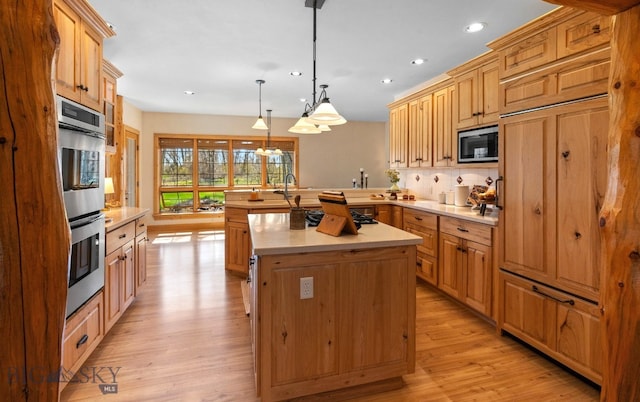 624 Rocking Horse Dr, Bozeman, MT 59718 - kitchen with light countertops, recessed lighting, stainless steel appliances, and a peninsula