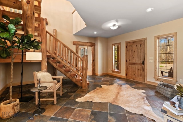 624 Rocking Horse Dr, Bozeman, MT 59718 - foyer featuring stairs, baseboards, a healthy amount of sunlight, and stone tile flooring