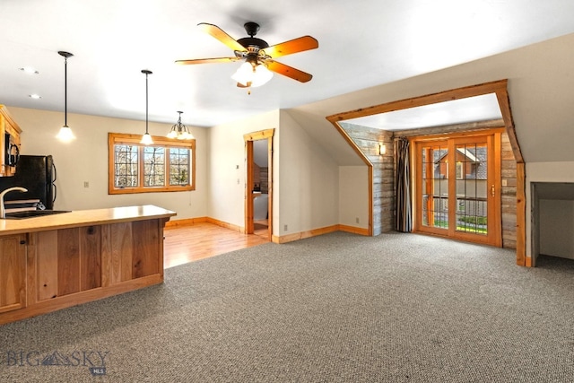 624 Rocking Horse Dr, Bozeman, MT 59718 - kitchen with a ceiling fan, hanging light fixtures, baseboards, freestanding refrigerator, and light carpet