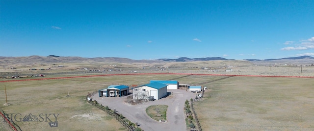 drone / aerial view with a mountain view and a rural view