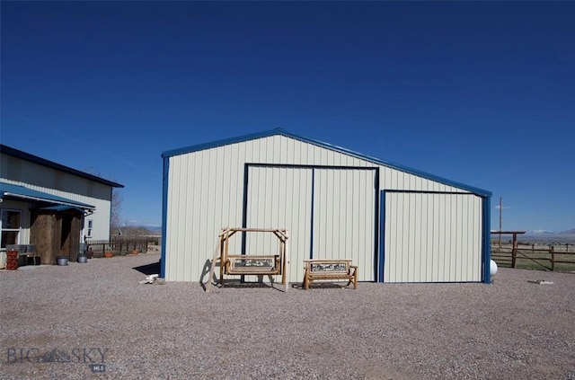 view of pole building featuring fence