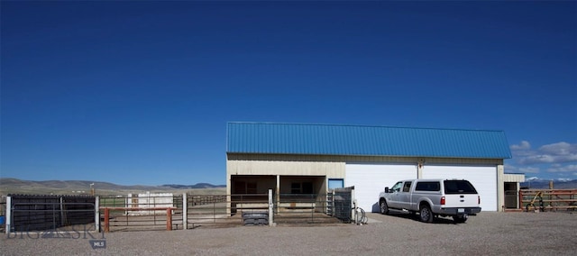 view of outdoor structure with an exterior structure, a mountain view, and an outbuilding