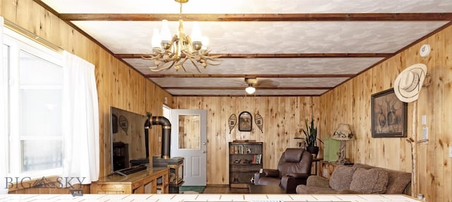 living room featuring a chandelier and wood walls