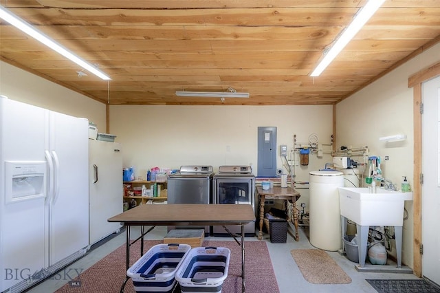 kitchen featuring electric panel, white refrigerator with ice dispenser, wooden ceiling, freestanding refrigerator, and washer and clothes dryer