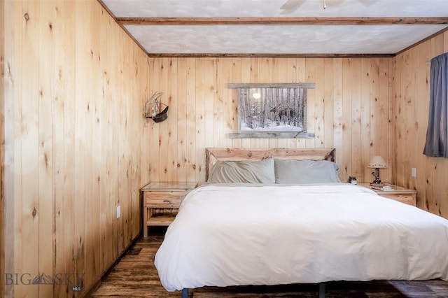 bedroom with wood walls and wood finished floors