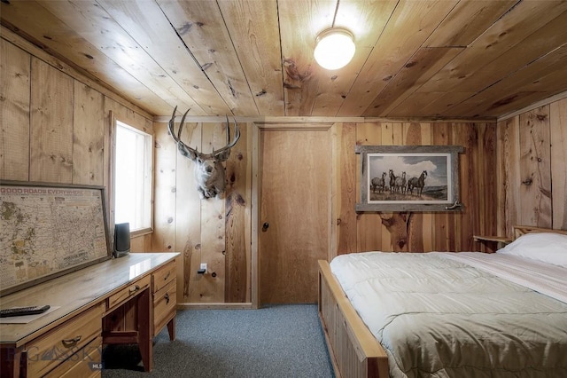 carpeted bedroom featuring wooden walls and wood ceiling