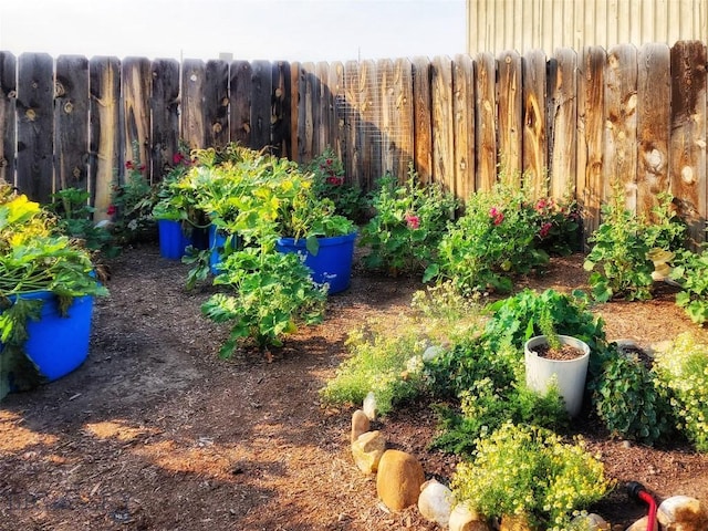 view of yard with fence and a garden