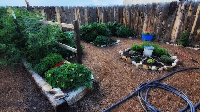 view of yard with fence and a garden