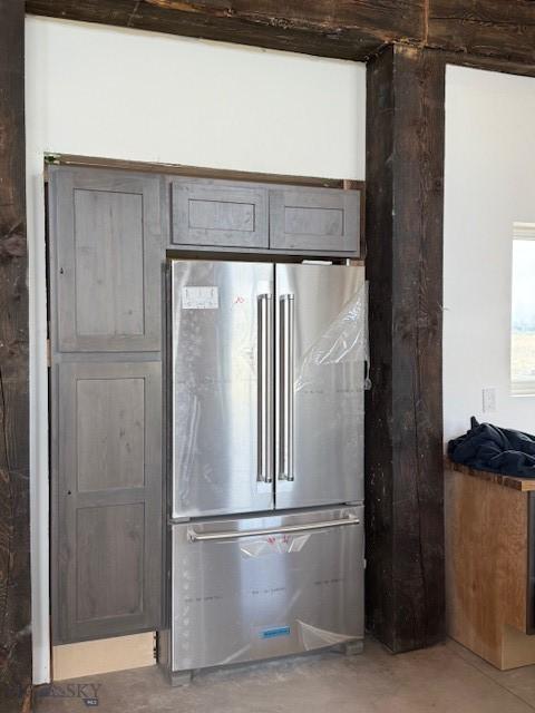 interior details featuring freestanding refrigerator and concrete flooring