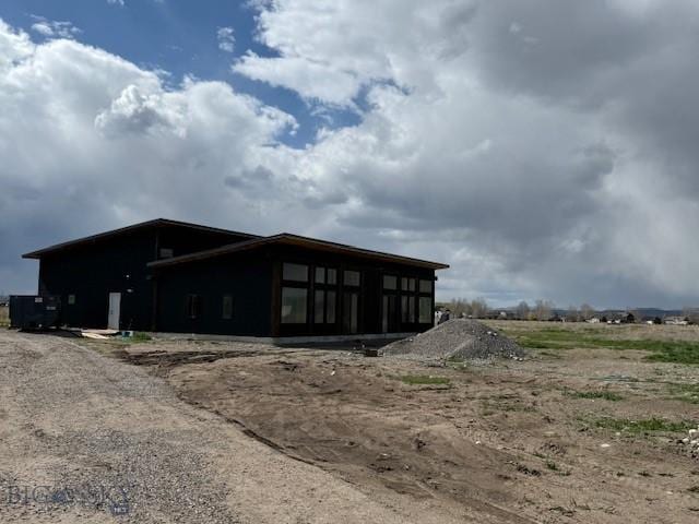 view of property exterior featuring a sunroom