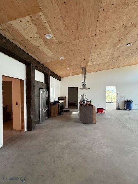 miscellaneous room with wooden ceiling and unfinished concrete floors