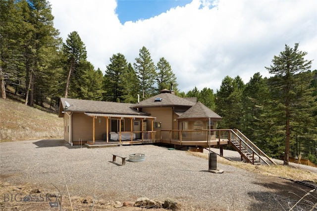 189 Quinn Creek Rd, Bozeman, MT 59715 - rear view of house featuring a gazebo, a wooden deck, and a forest view