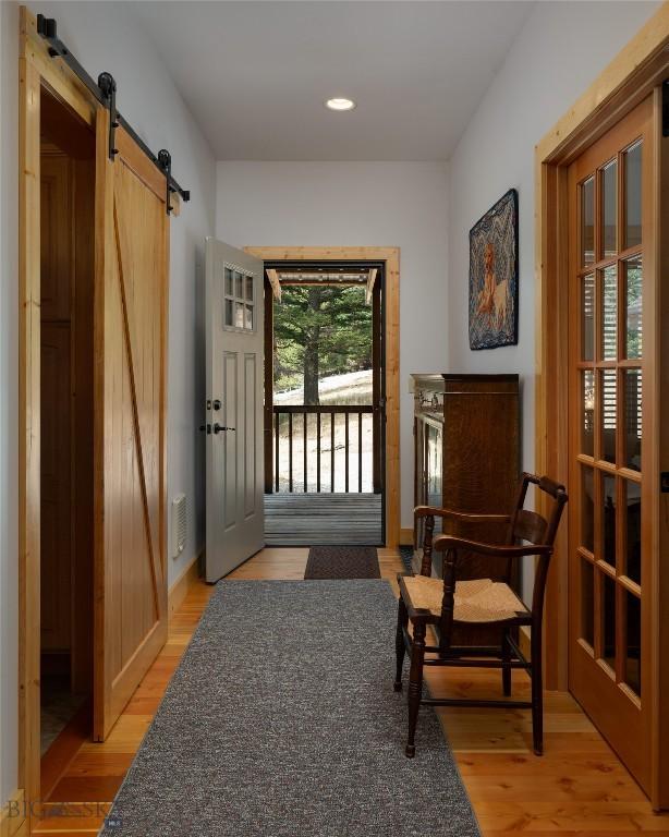 189 Quinn Creek Rd, Bozeman, MT 59715 - doorway to outside featuring light wood finished floors, a barn door, and recessed lighting