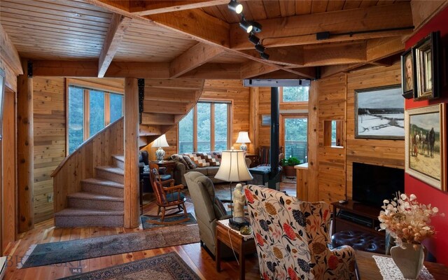 189 Quinn Creek Rd, Bozeman, MT 59715 - living room with beamed ceiling, wooden walls, wood-type flooring, and wooden ceiling