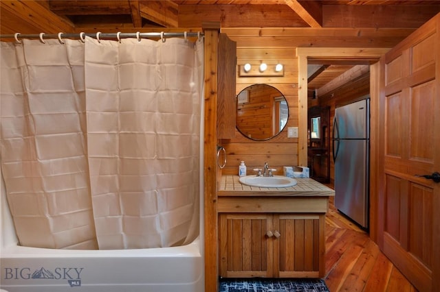 189 Quinn Creek Rd, Bozeman, MT 59715 - full bath with wood-type flooring, beam ceiling, shower / tub combo with curtain, wood walls, and vanity