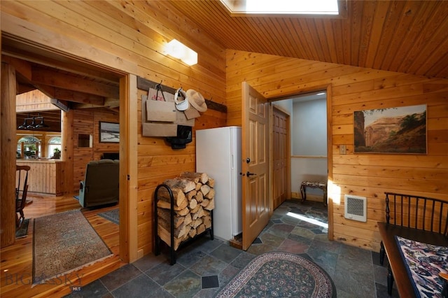 189 Quinn Creek Rd, Bozeman, MT 59715 - corridor featuring wood walls, vaulted ceiling, wooden ceiling, heating unit, and stone finish flooring