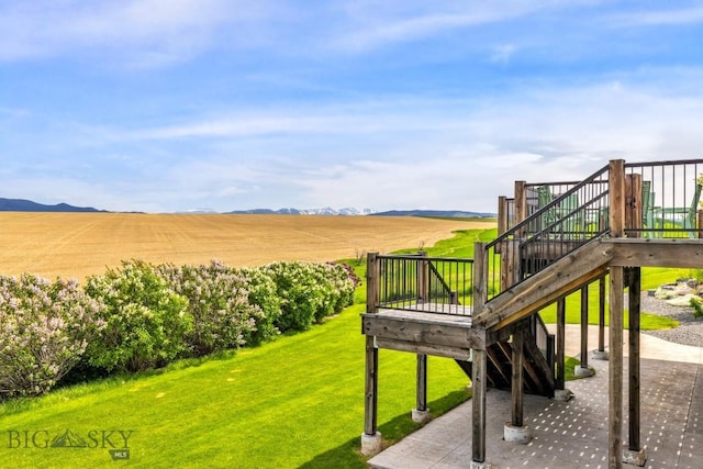 14549 High Flat Rd, Bozeman, MT 59718 - view of green lawn featuring stairs, a wooden deck, and a view of rural / pastoral area