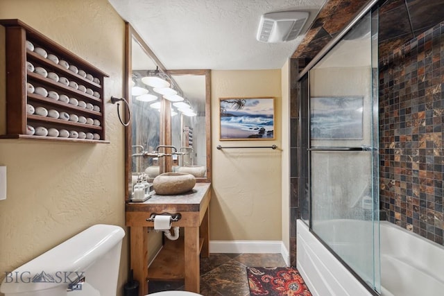 381 Bozeman Trail Rd, Bozeman, MT 59715 - full bath with toilet, enclosed tub / shower combo, a textured ceiling, baseboards, and vanity
