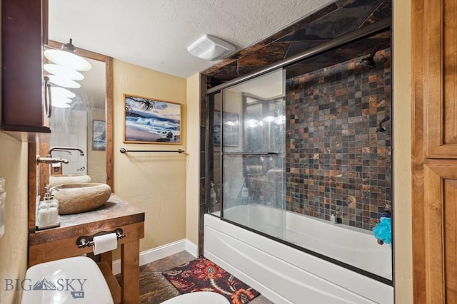 381 Bozeman Trail Rd, Bozeman, MT 59715 - full bath featuring vanity, a textured ceiling, baseboards, and bath / shower combo with glass door