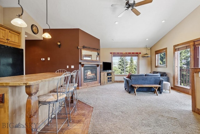 381 Bozeman Trail Rd, Bozeman, MT 59715 - carpeted living area with recessed lighting, vaulted ceiling, ceiling fan, a bar, and a glass covered fireplace
