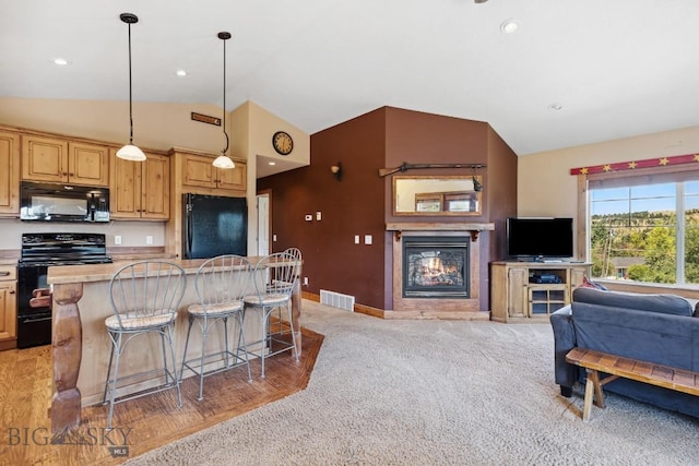381 Bozeman Trail Rd, Bozeman, MT 59715 - kitchen with black appliances, visible vents, vaulted ceiling, light countertops, and open floor plan
