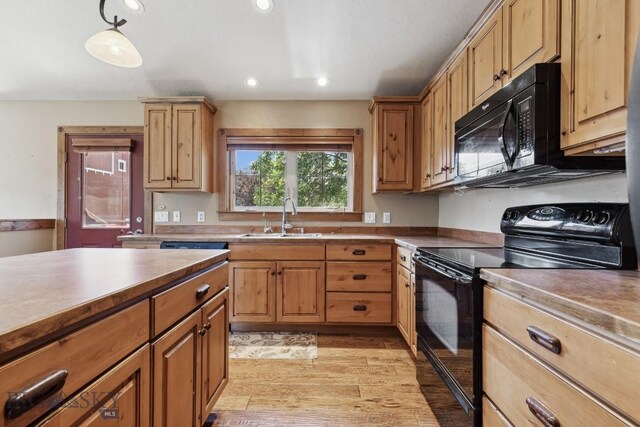 381 Bozeman Trail Rd, Bozeman, MT 59715 - kitchen with black appliances, light wood-style floors, recessed lighting, and a sink