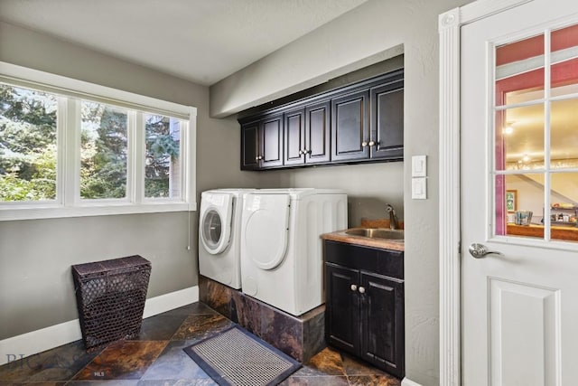 381 Bozeman Trail Rd, Bozeman, MT 59715 - washroom featuring a sink, cabinet space, stone finish floor, washer and clothes dryer, and baseboards