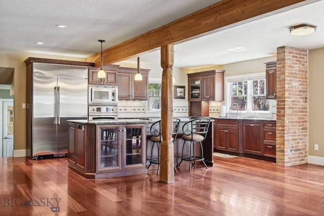381 Bozeman Trail Rd, Bozeman, MT 59715 - kitchen featuring built in appliances, decorative backsplash, dark wood-type flooring, and glass insert cabinets