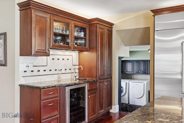 381 Bozeman Trail Rd, Bozeman, MT 59715 - bar featuring beverage cooler, a sink, wet bar, washing machine and clothes dryer, and built in refrigerator