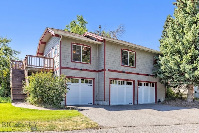 381 Bozeman Trail Rd, Bozeman, MT 59715 - view of property exterior featuring stairs, a wooden deck, aphalt driveway, and an attached garage
