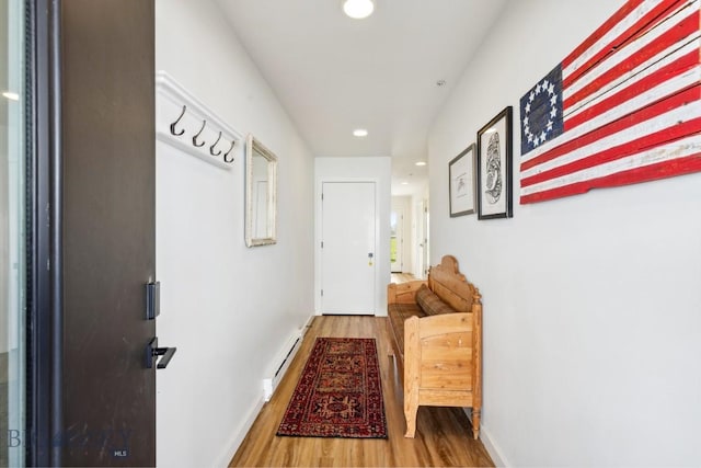 hall with recessed lighting, baseboards, baseboard heating, and wood finished floors