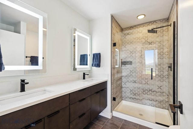 bathroom with a sink, tile patterned flooring, and a stall shower