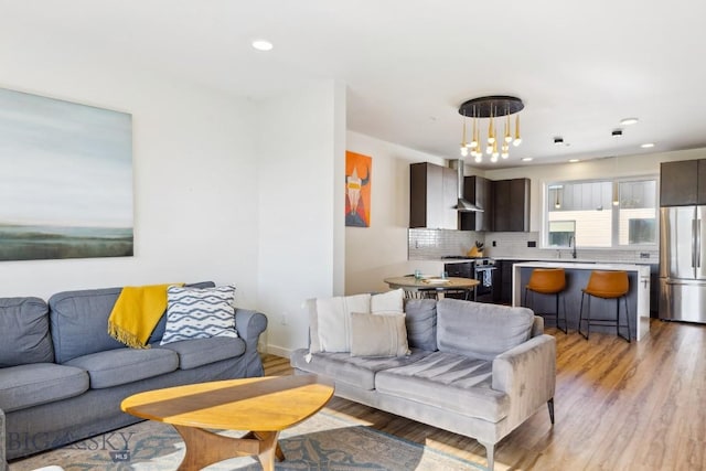 living area featuring light wood-style floors and recessed lighting